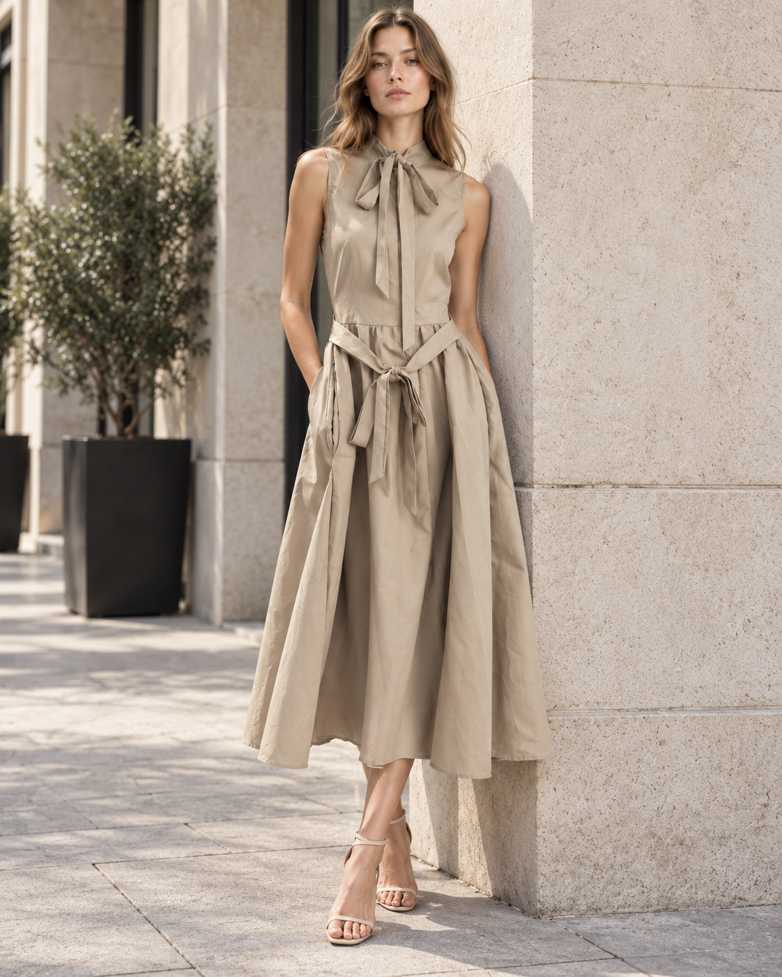 French Elegant Sleeveless Tie-Neck Midi Dress with Defined Waist and Flowing Pleated Skirt